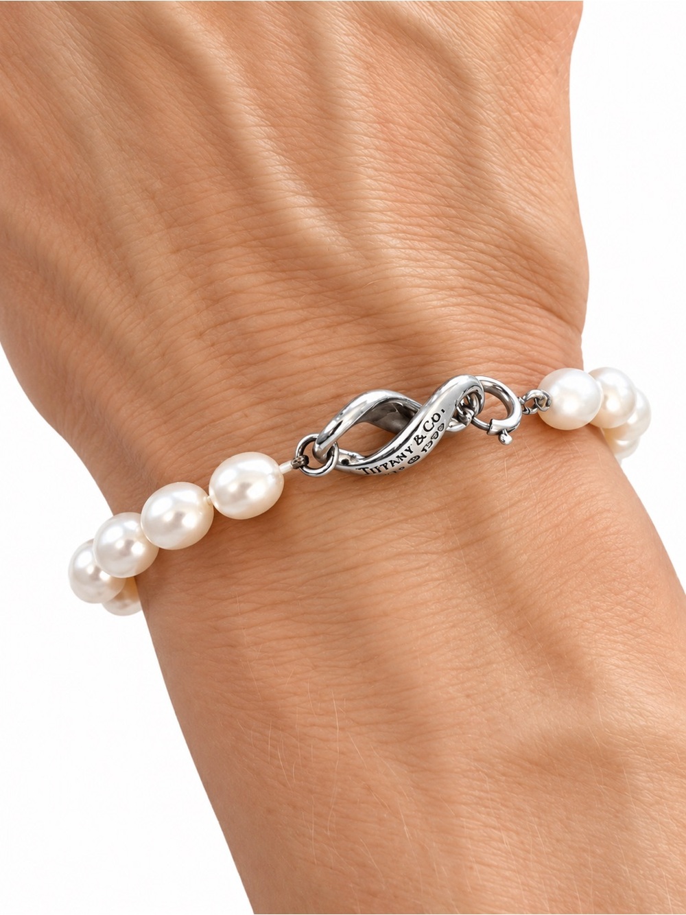 Tiffany & Co. Pearl bracelet with sterling silver infinity clasp.
